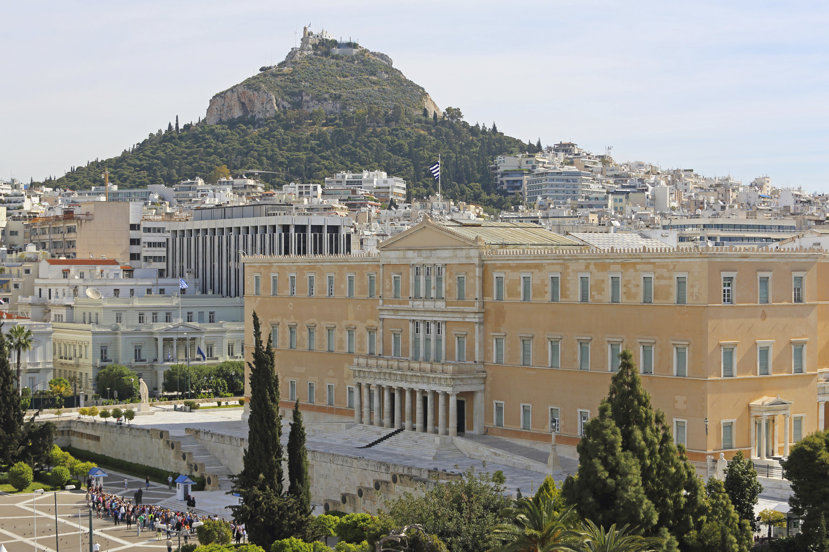 Athens, Greece - May 02, 2015: Tourists in front of Greek Parliament and Mount Lycabettus in Athens, Greece.