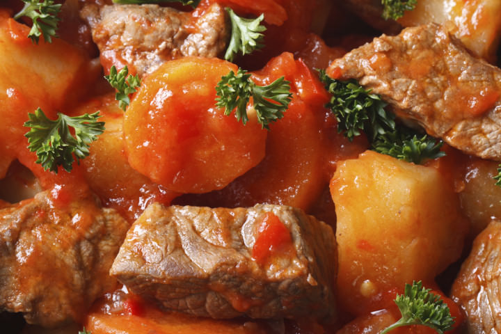 stew with vegetables in a tomato macro. view from above horizontal. background