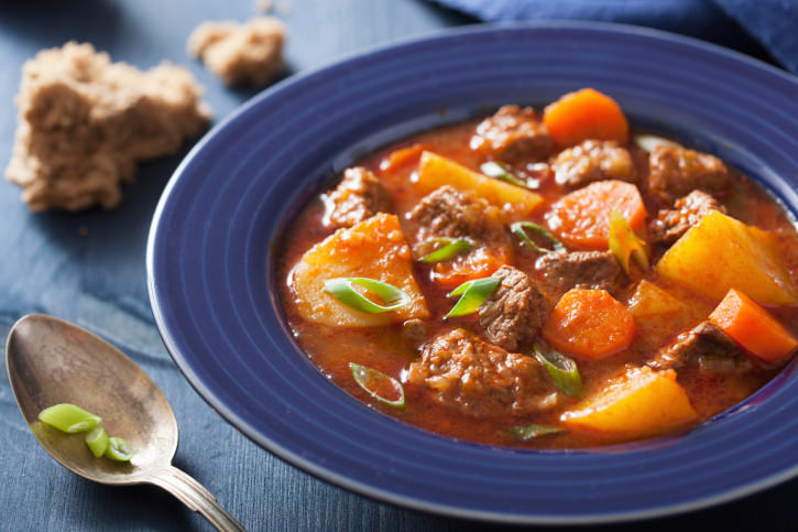 beef stew with potato and carrot in blue plate