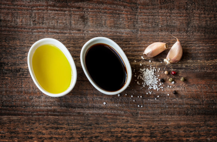 Vinaigrette dressing ingredients on vintage wood