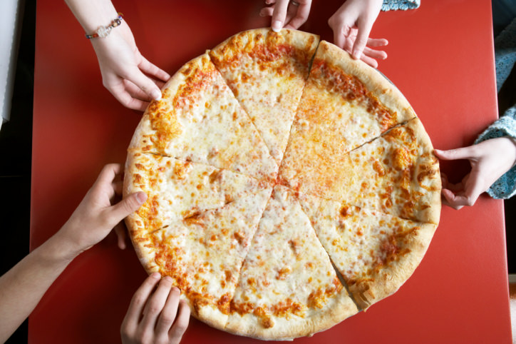 Teenagers Taking Pizza Slices at Restaurant