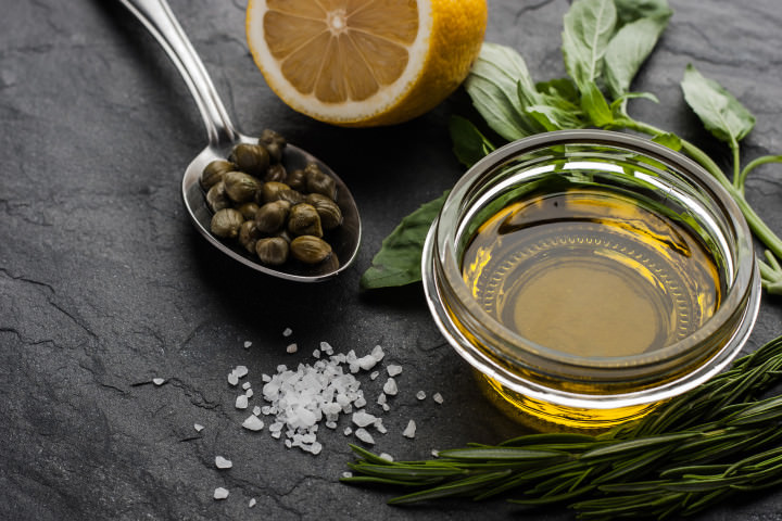 Olive oil  with lemon , capers and different greens