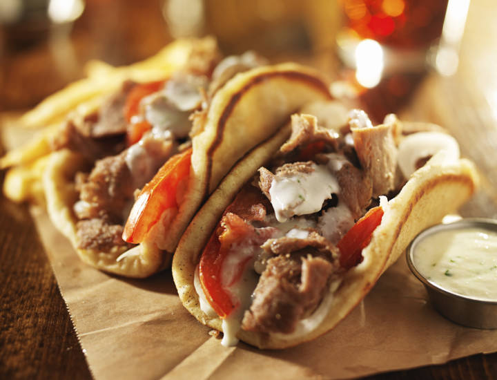 greek gyros with tzatziki sauce and fries close up