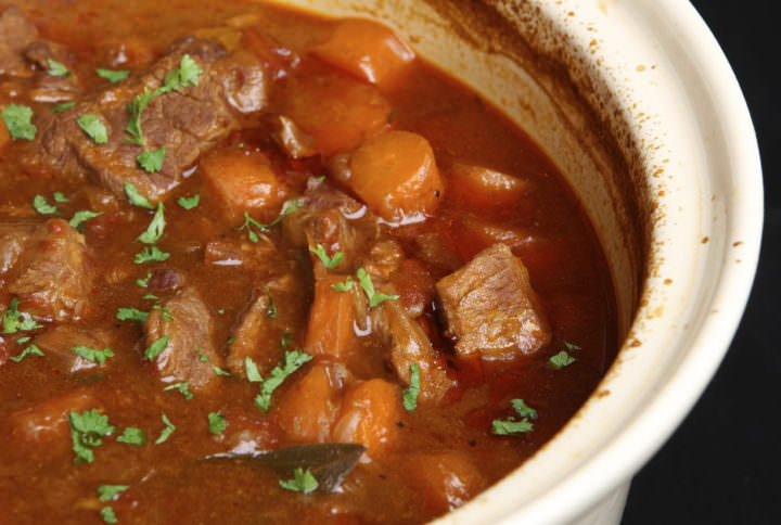 Slow-cooked beef stew in casserole dish.