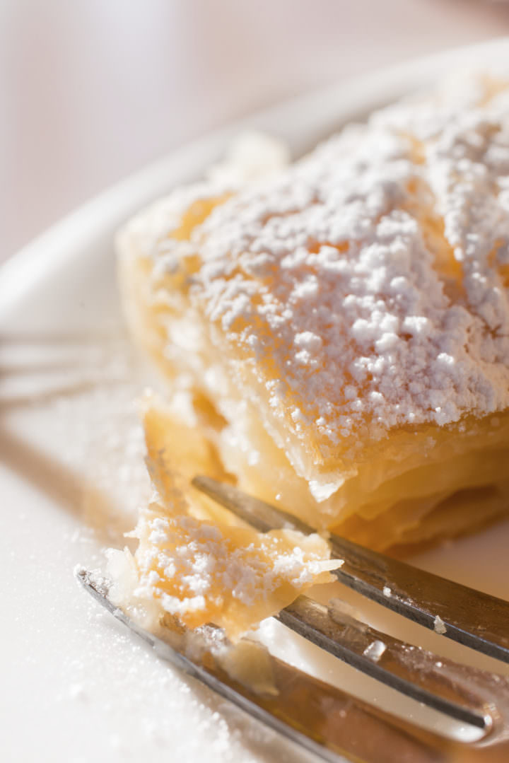 Macro closeup of traditional greek bougatsa, covered in powdered sugar.