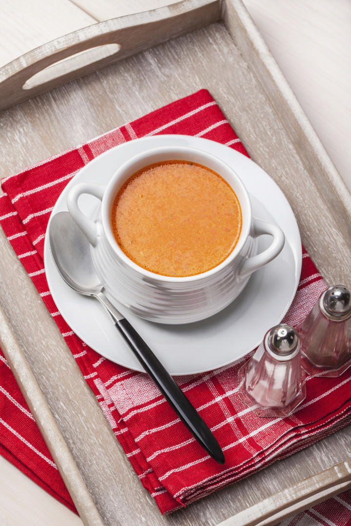 Fresh tomato soup in a white bowl. Selctive focus.