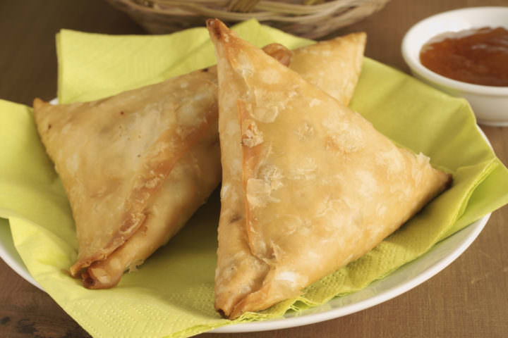Samosas a spicy blend of vegetables or meat wrapped in a deep fried triangular pastry parcel