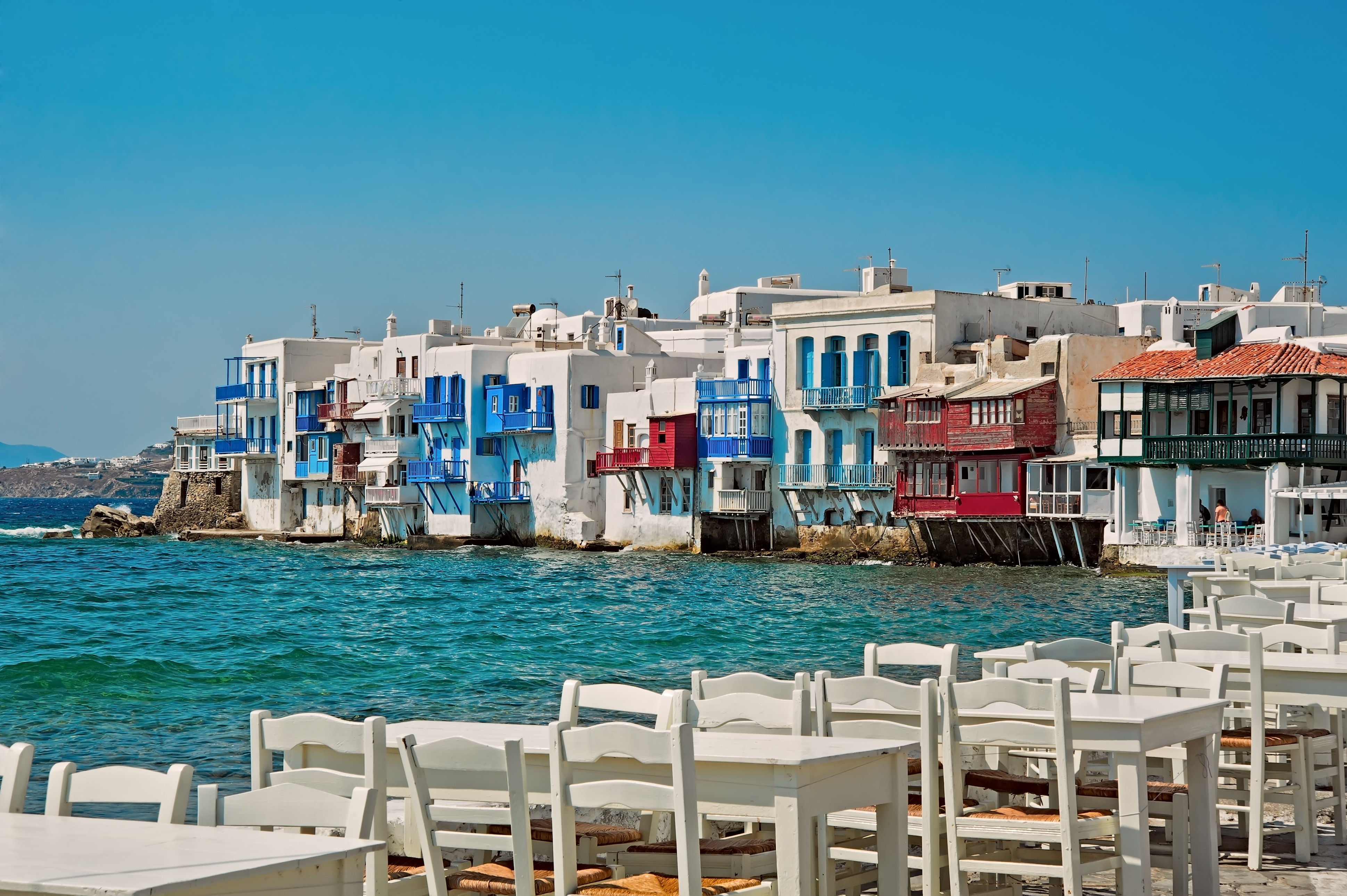 Alefkandra, Little Venice in Mykonos, Greece with cafe chairs at foreground