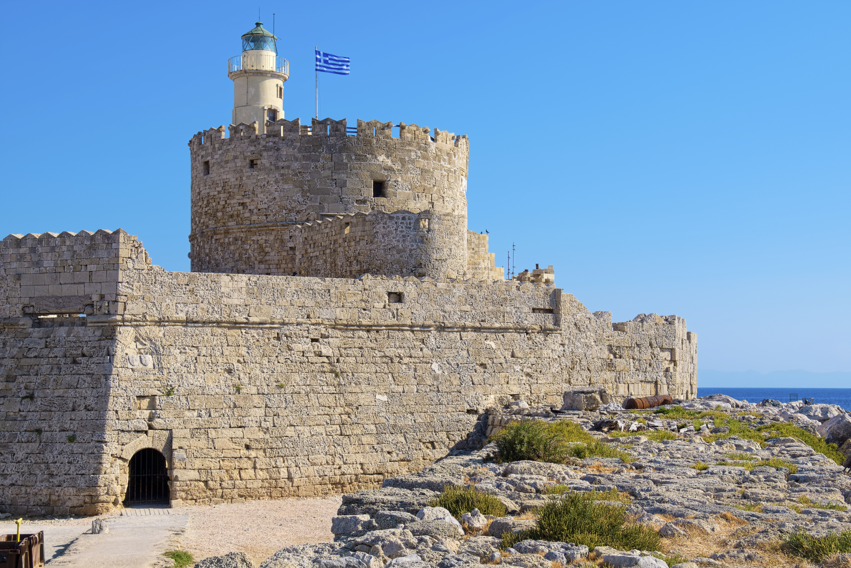 Old Agios Nikolaos fortress and lighthouse in Mandraki Harbour. Rhodes, Dodecanese, Greece