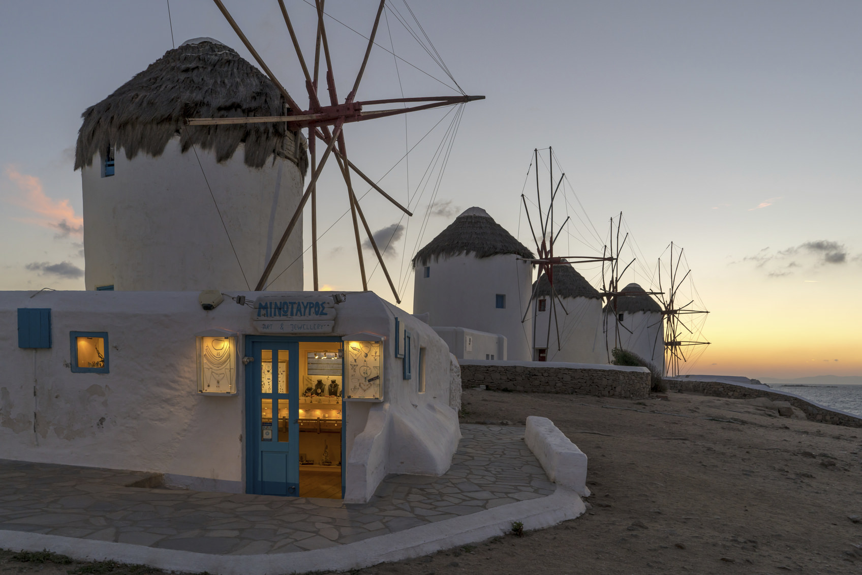 Mykonos Island, Greece - October 14, 2015: Mykonos is a travel location of mediterraneon cruise tour, where almost all the houses are painted in white and doors, windows and stairs are in blue. There stands windmills on the hill facing the sea, which look apparently imitations but fascinate tourists.