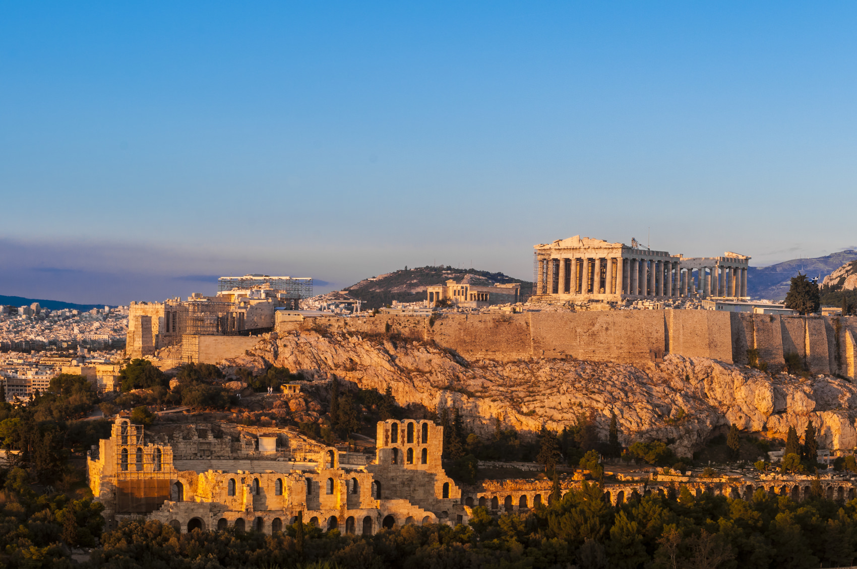 Acropolis, Parthenon and Theatre of Herodes Atticus, Athens, Greece. Golden late light.