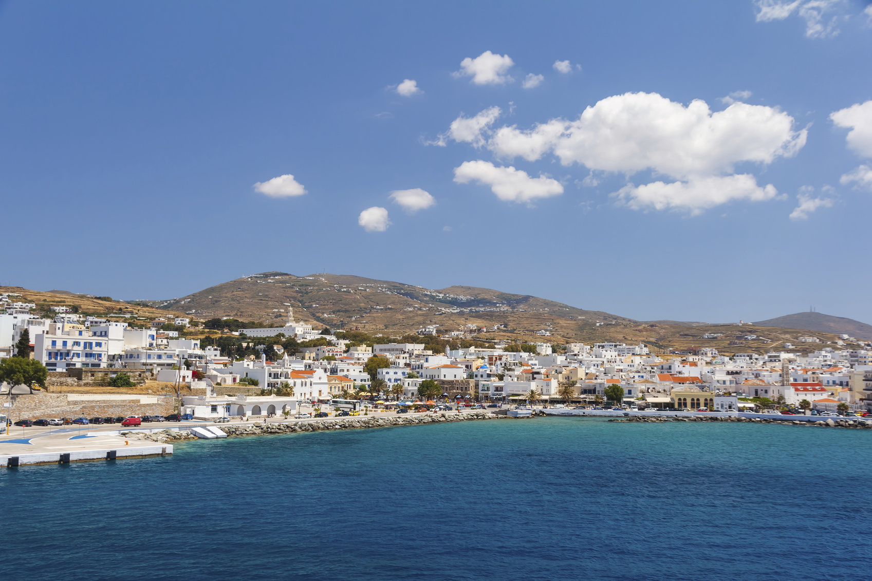 Tinos city and harbor in Cyclades against a blue sky, Greece