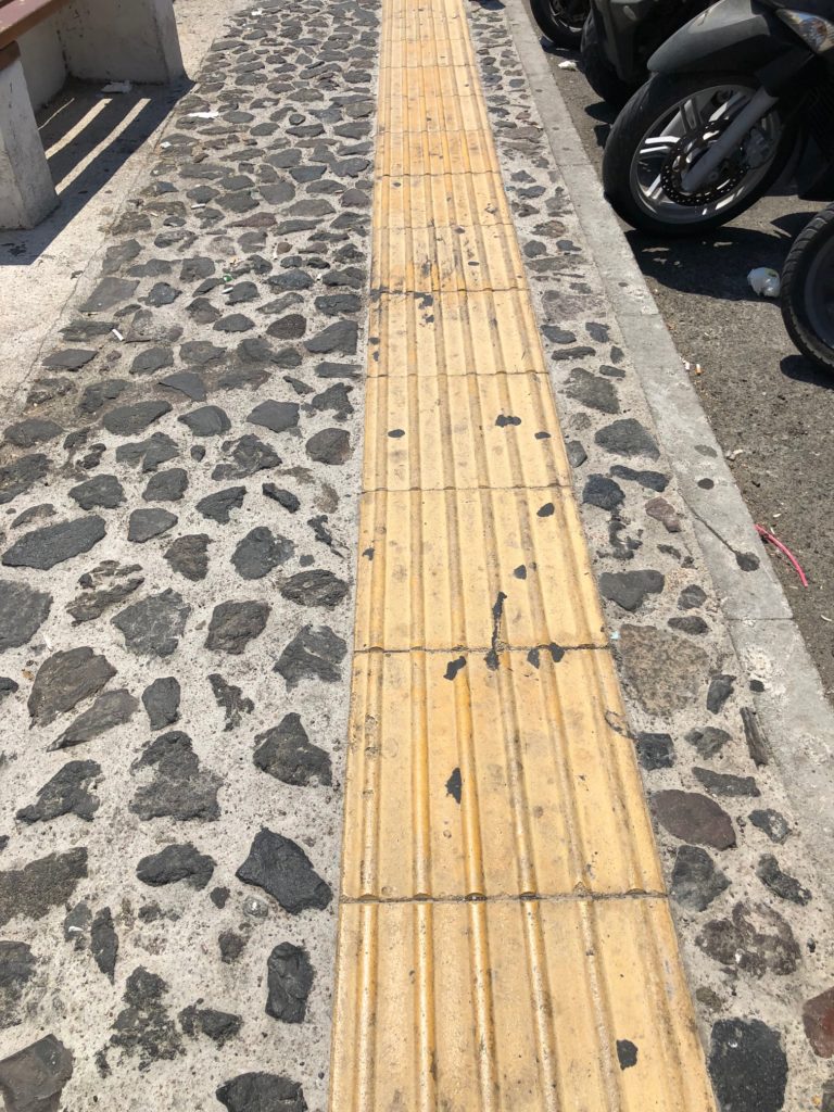 Why Are There Yellow Grooves in the Sidewalks of Greece?